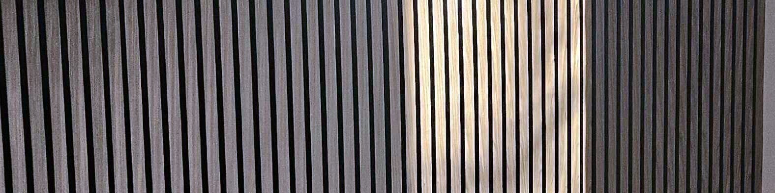 Fluted wall panel in raking light, close up