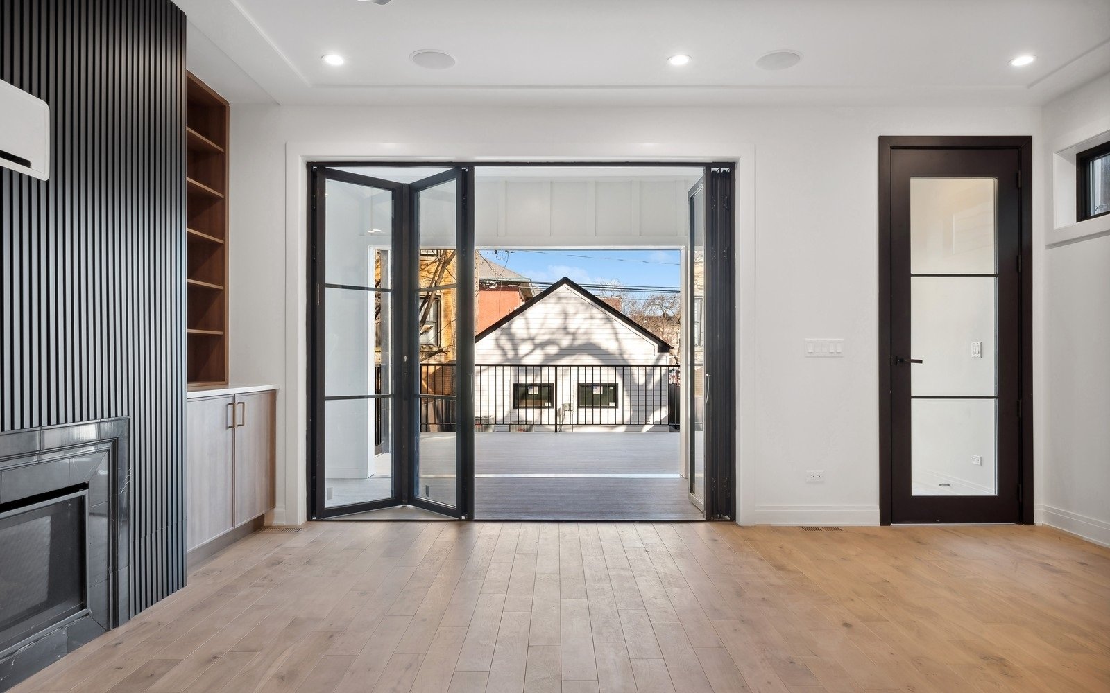 Black-frame glass doors to the yard